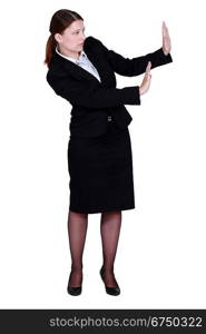 woman in a suit trying to protect herself with her hands