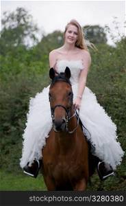 Woman in a wedding dress on a horse.