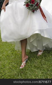 Woman in a wedding dress showing her feet