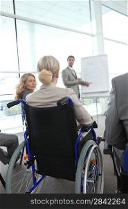 Woman in a wheelchair at meeting
