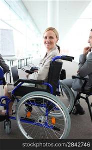 Woman in a wheelchair watching a presentation