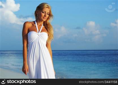 woman in a white dress on the ocean coast