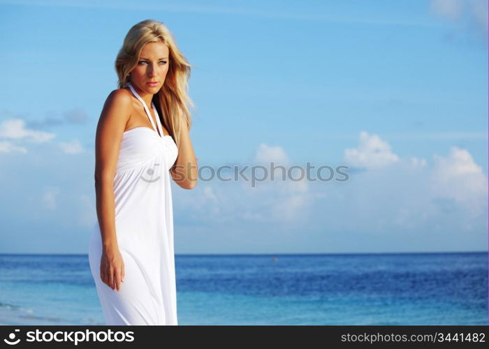 woman in a white dress on the ocean coast