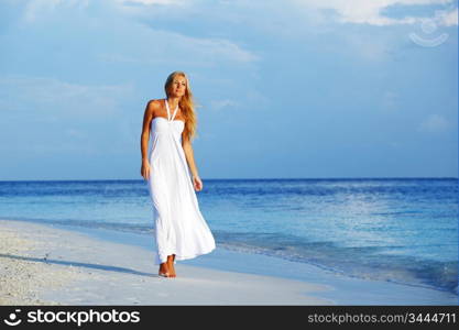 woman in a white dress on the ocean coast