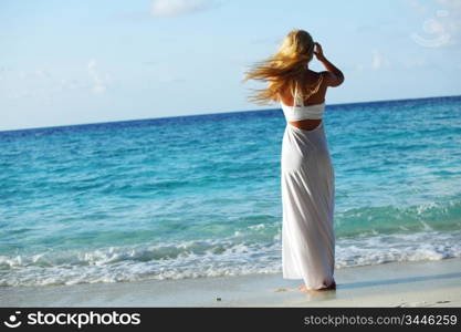 woman in a white dress on the ocean coast