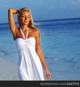 woman in a white dress on the ocean coast