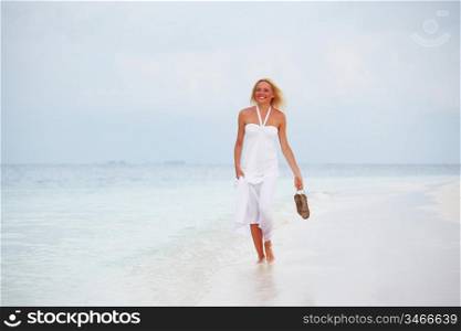 woman in a white dress on the ocean coast