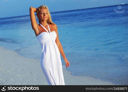 woman in a white dress on the ocean coast