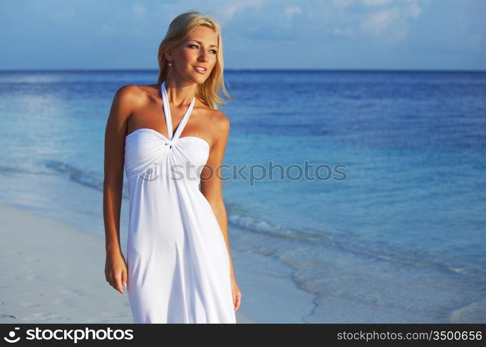 woman in a white dress on the ocean coast