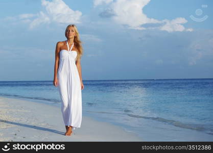 woman in a white dress on the ocean coast