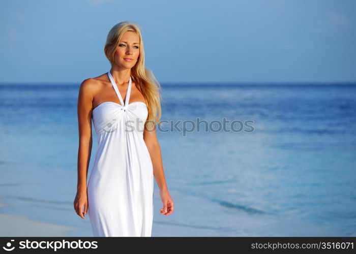 woman in a white dress on the ocean coast