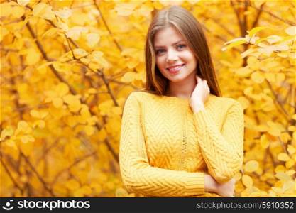 Woman in autumn forest. Smiling young woman in autumn forest