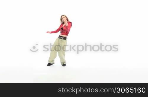 Woman in baggy pants and red top hip hop dancing, forward movement