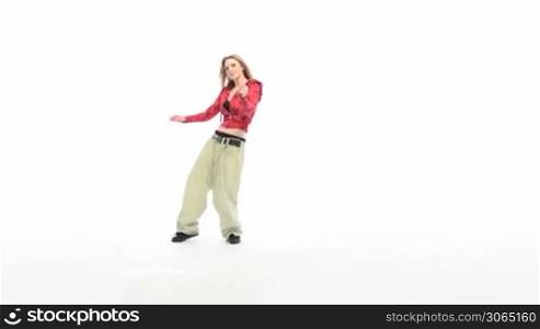 Woman in baggy pants and red top hip hop dancing, forward movement