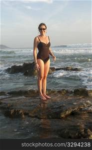 Woman in bathing suit along Mal Pais coastline in San Jose Costa Rica