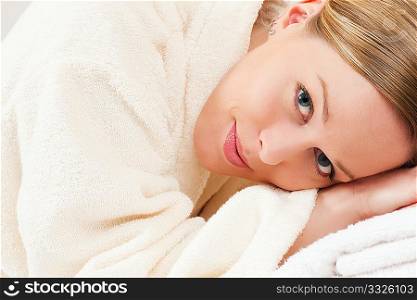 Woman in bathrobe relaxing in a spa situation