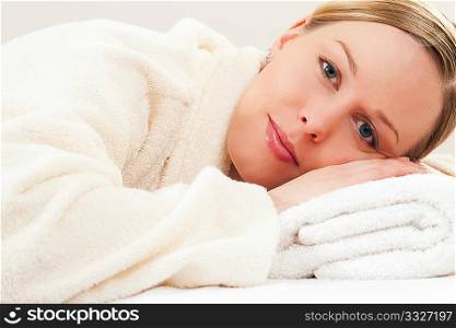 Woman in bathrobe relaxing in a spa situation