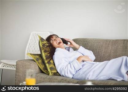 Woman in bathrobe talking on phone