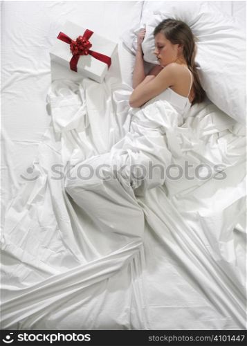 woman in bed with his present