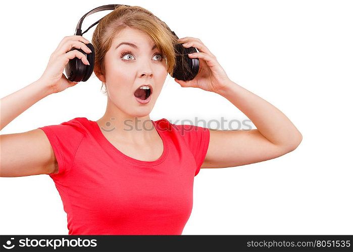 Woman in big headphones listening music isolated. Woman in red shirt big headphones listening music mp3. Smiling female model on white. People leisure happiness concept.