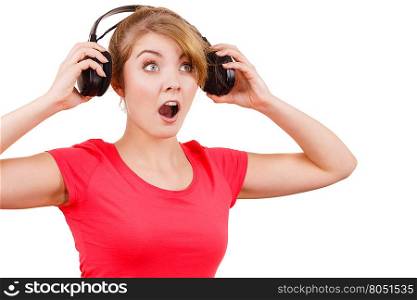 Woman in big headphones listening music isolated. Woman in red shirt big headphones listening music mp3. Smiling female model on white. People leisure happiness concept.