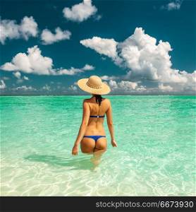 Woman in bikini at beach in Maldives. Woman in bikini at tropical beach in Maldives