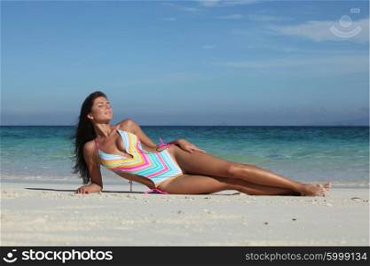 Woman in bikini at tropical beach. Woman in bikini enjoy laying at tropical beach