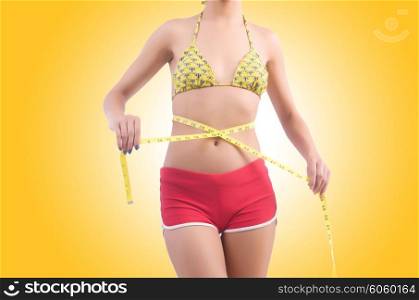 Woman in bikini in diet concept isolated on white