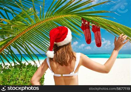Woman in bikini on a tropical beach at christmas