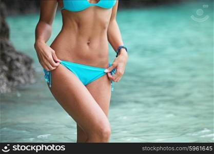 Woman in bikini on beach. Beautiful woman in bikini posing in thai beach with rocks