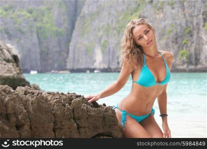 Woman in bikini on beach. Beautiful woman in bikini posing in thai beach with rocks