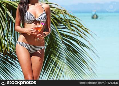Woman in bikini on beach . Woman in bikini with cocktail on a tropical beach