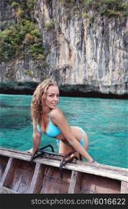 Woman in bikini on boat . Woman in bikini on boat floating in beautiful lagoon in Thailand