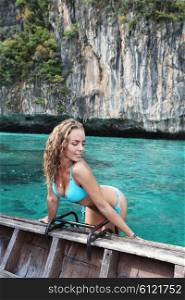 Woman in bikini on boat. Woman in bikini on boat floating in beautiful lagoon in Thailand