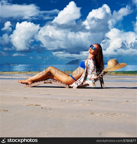 Woman in bikini on tropical beach at Seychelles