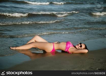 Woman in bikini relax and enjoy on beach on sea water background