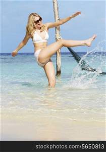 Woman In Bikini Splashing In Beautiful Tropical Sea