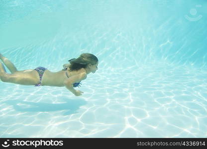 Woman in bikini swimming in pool