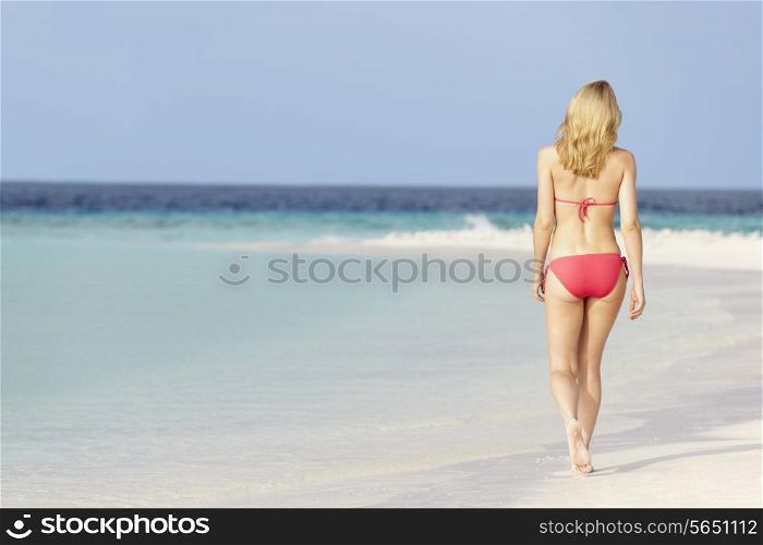 Woman In Bikini Walking On Beautiful Tropical Beach