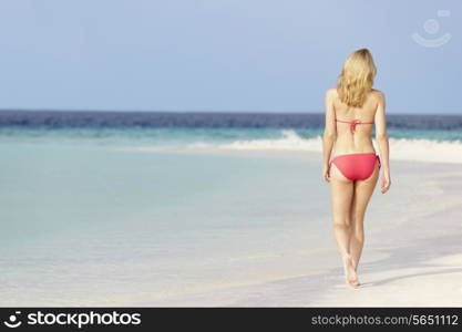 Woman In Bikini Walking On Beautiful Tropical Beach