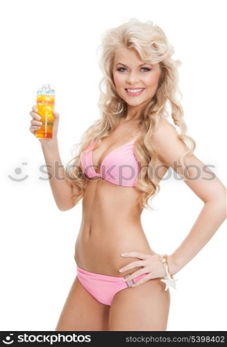 woman in bikini with glass of juice or cocktail