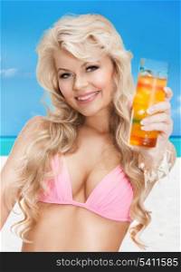 woman in bikini with glass of juice or cocktail