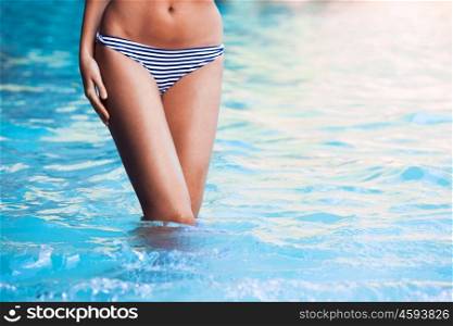 Woman in bikini. Woman with perfect body in bikini posing in tropical sea