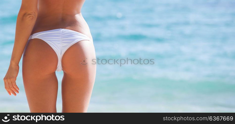 Woman in bikini. Woman with perfect body in bikini posing in tropical sea