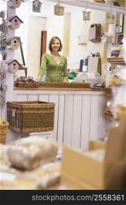 Woman in birdhouse store smiling