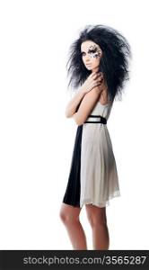 Woman in black and white dress with black hair and art make up on white background
