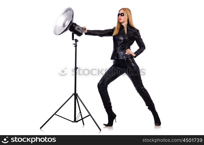 Woman in black leather dress in studio shootout