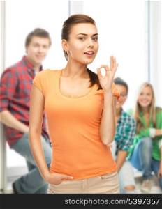 woman in blank t-shirt showing ok gesture at school
