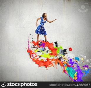 Woman in blue dress. Young woman in blue dress walking on colorful splashes