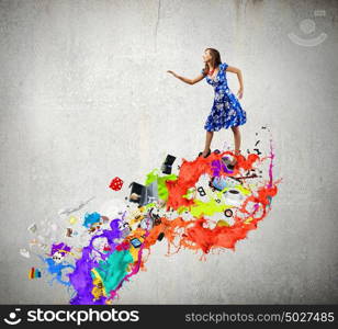 Woman in blue dress. Young woman in blue dress walking on colorful splashes